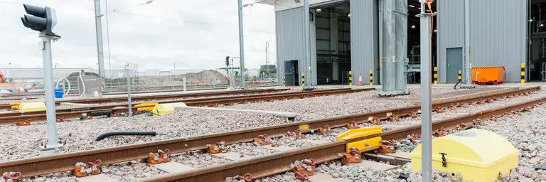 A Zonegreen DPPS derailler installed outside a large depot.