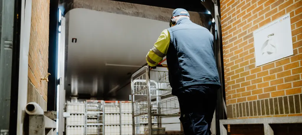 A worker unloading goods from a rigid vehicle at a loading bay, illustrating the safety risk that the Salvo Steering Wheel Lock is designed to prevent