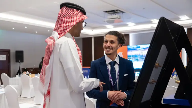 Discussion between two attendees at Safety by Design in Saudi Arabia