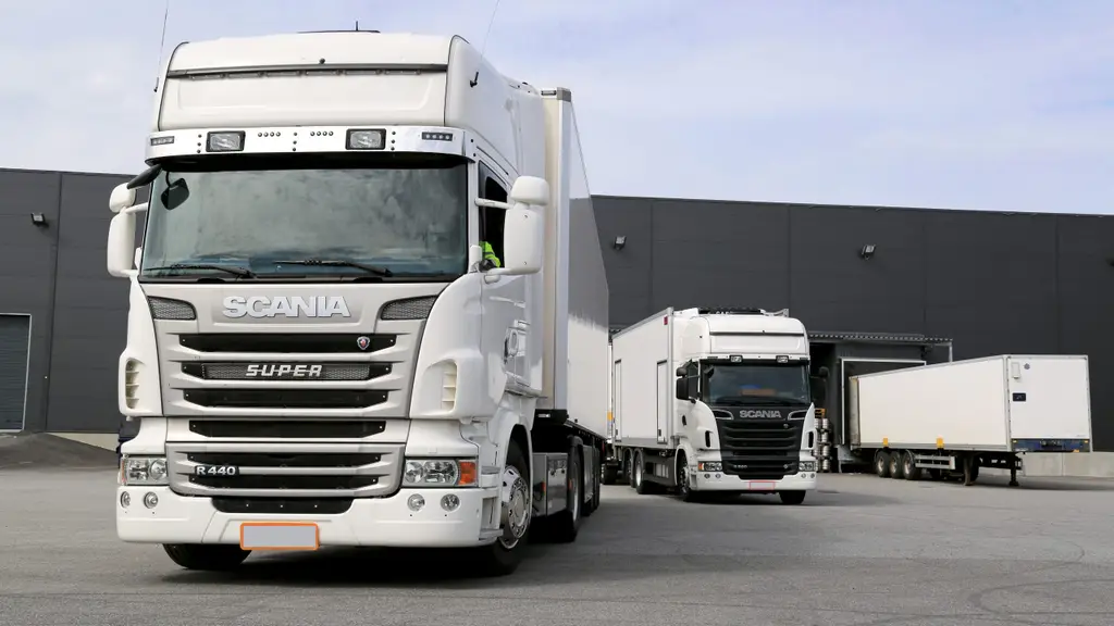 White Scania Trucks Ready to Unload at Warehouse Building