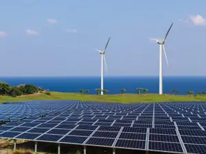 Solar panels and wind turbines, representing renewable energy sources.