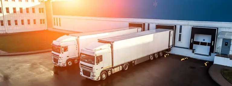 trucks are loaded in a modern logistics center..