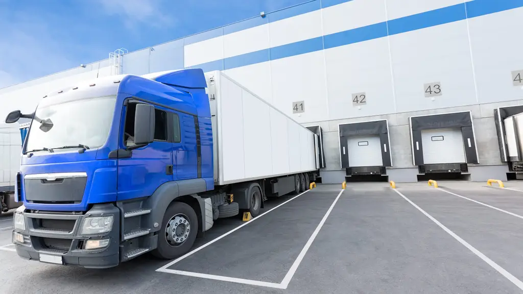 Blue Truck and Gates of Big distribution warehouse
