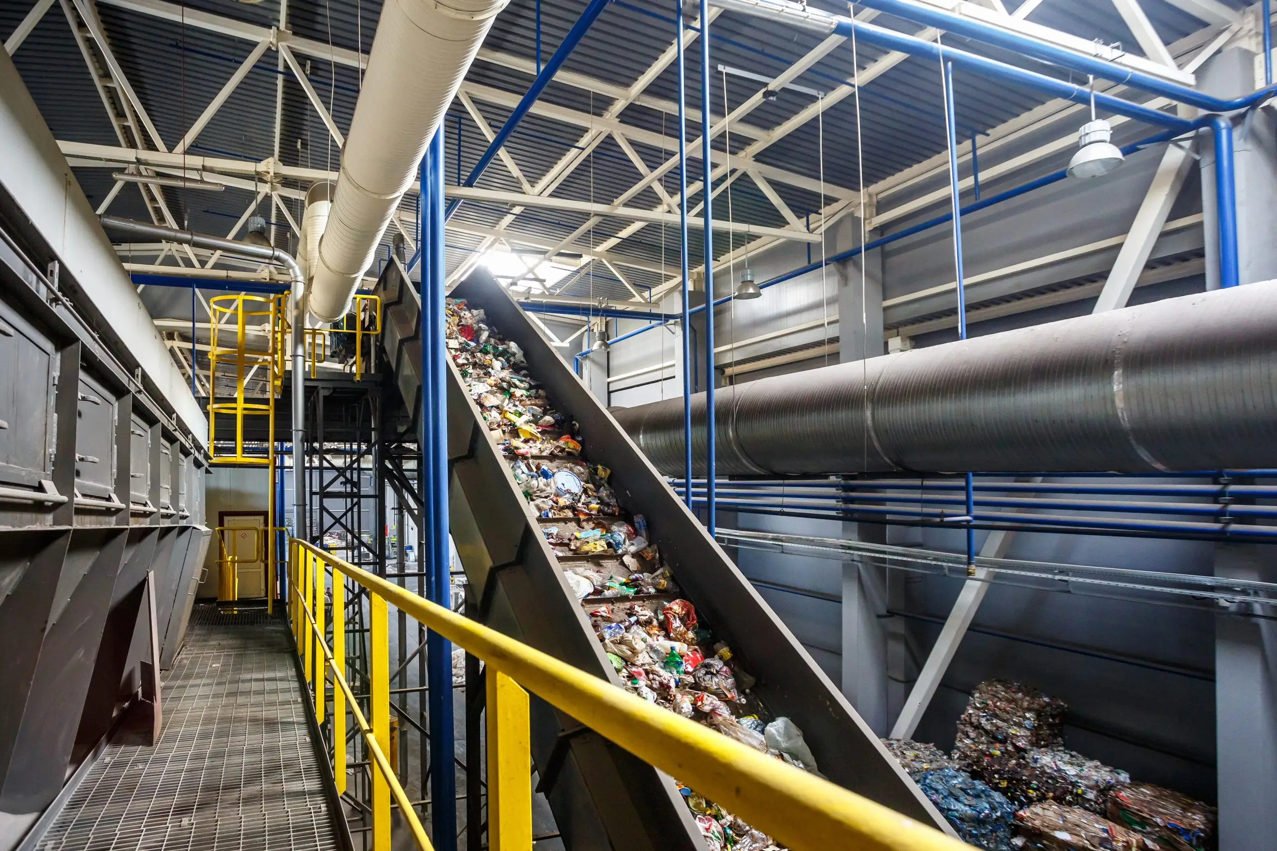 Waste and recycling moving along a conveyor belt in a processing plant