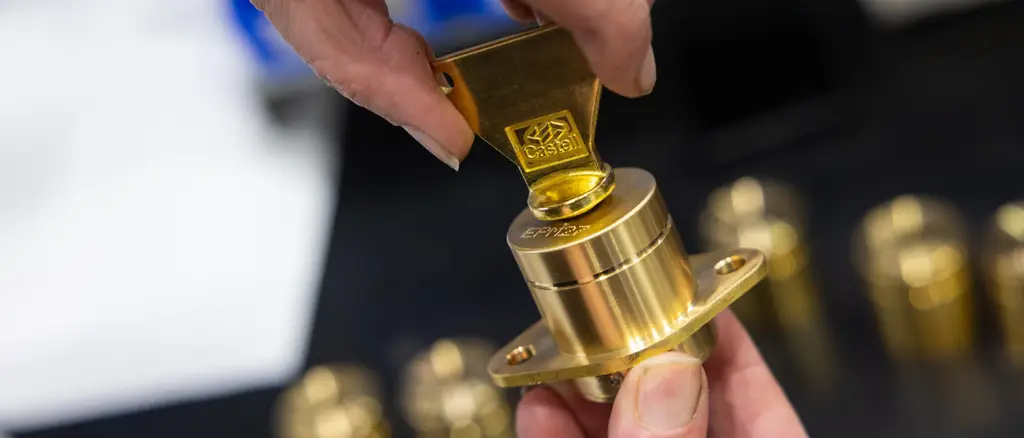 Castell key in gold being twisted inside a lock