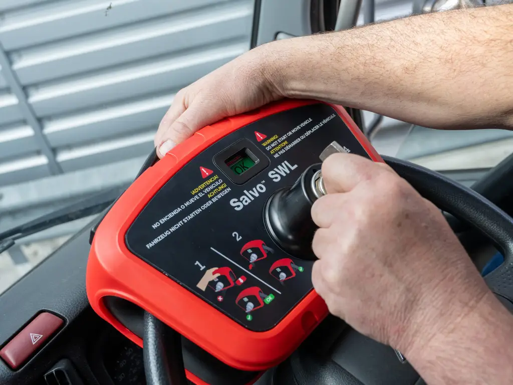 A worker fitting the Salvo steering wheel lock onto the steering wheel of a rigid vehicle