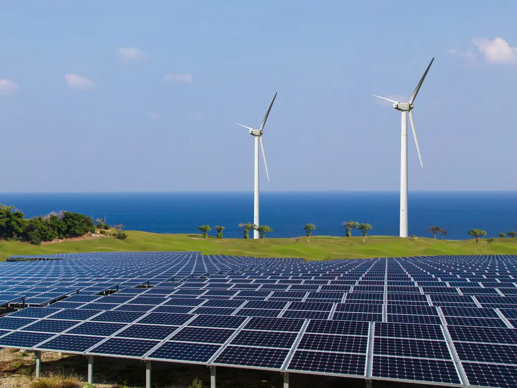 Solar panels and wind turbines, representing renewable energy sources.