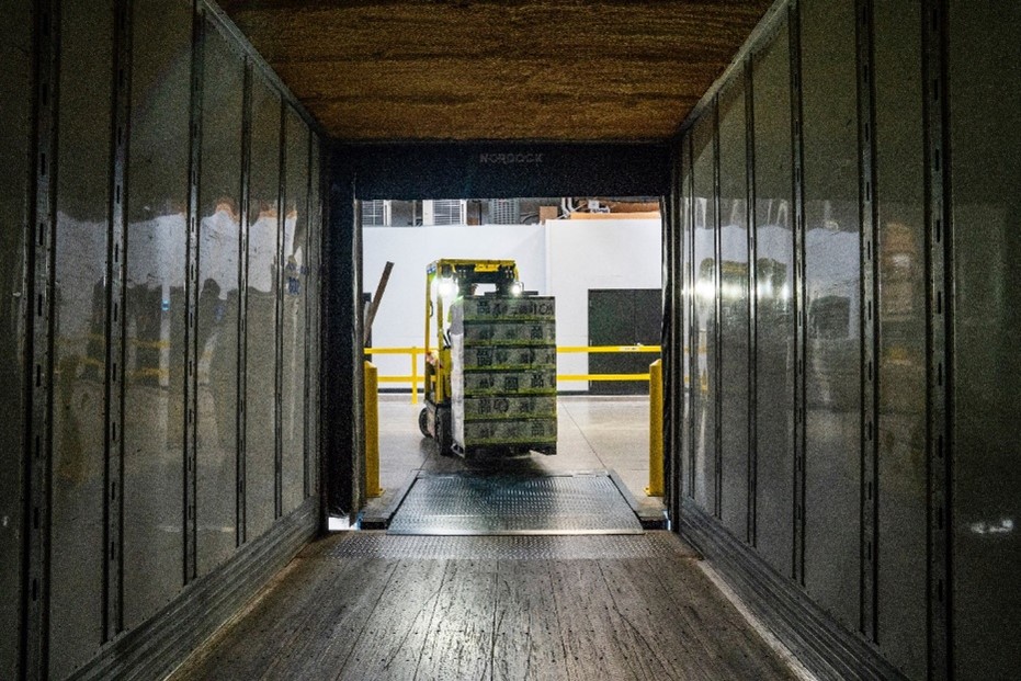 Forklift using to transport a pallet within a articulated lorries.