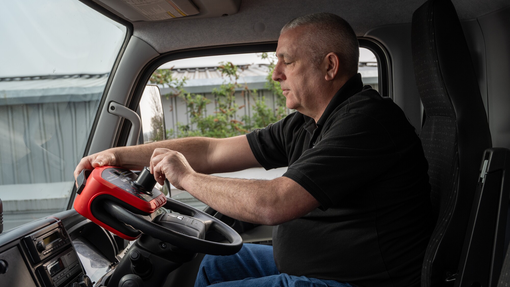 Driver operating a Salvo Steering Wheel Lock, turning the key in the lock of a vehicle